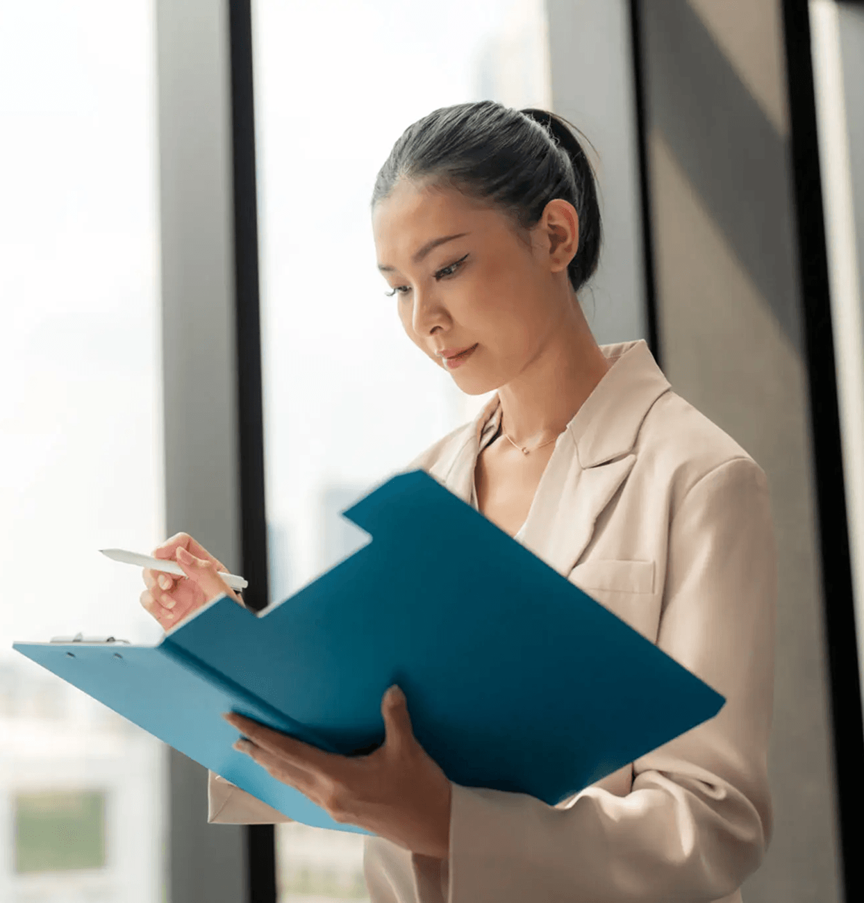 Professional woman holding a blue folder