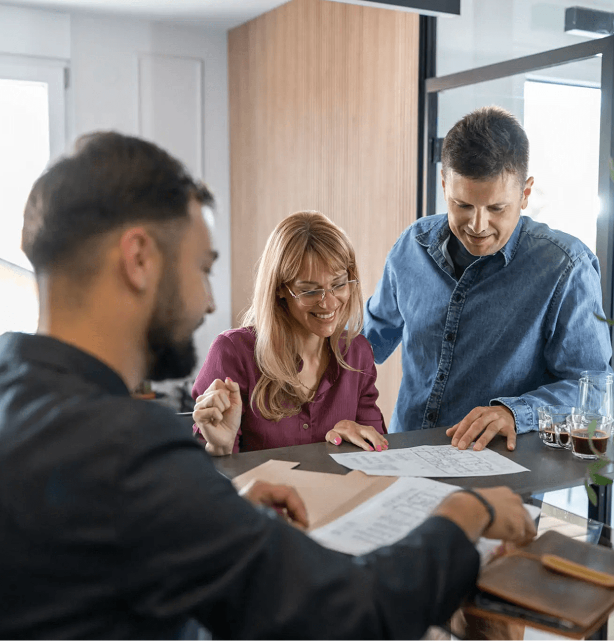 Couple reviewing documents with advisor