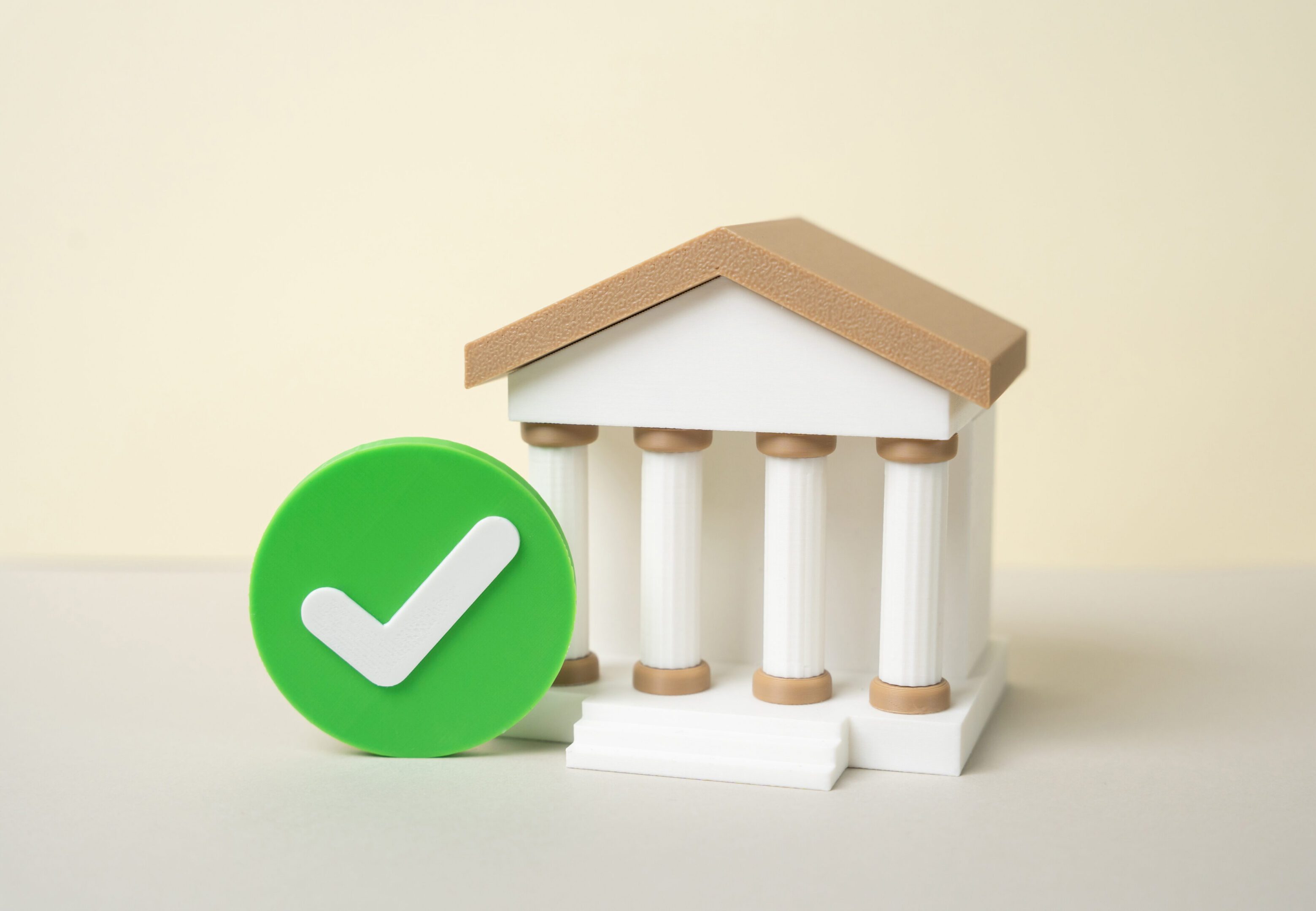 Bank and green checkmark. The bank has passed tests and verification as reliable. Mortgage loan approval. Financial trust concept, compliance success and customer confidence. Secure lending